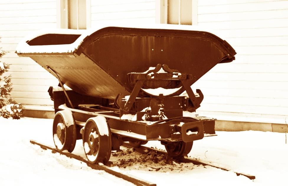 A restored cast-iron side-dump shale car outside the Russell Museum.