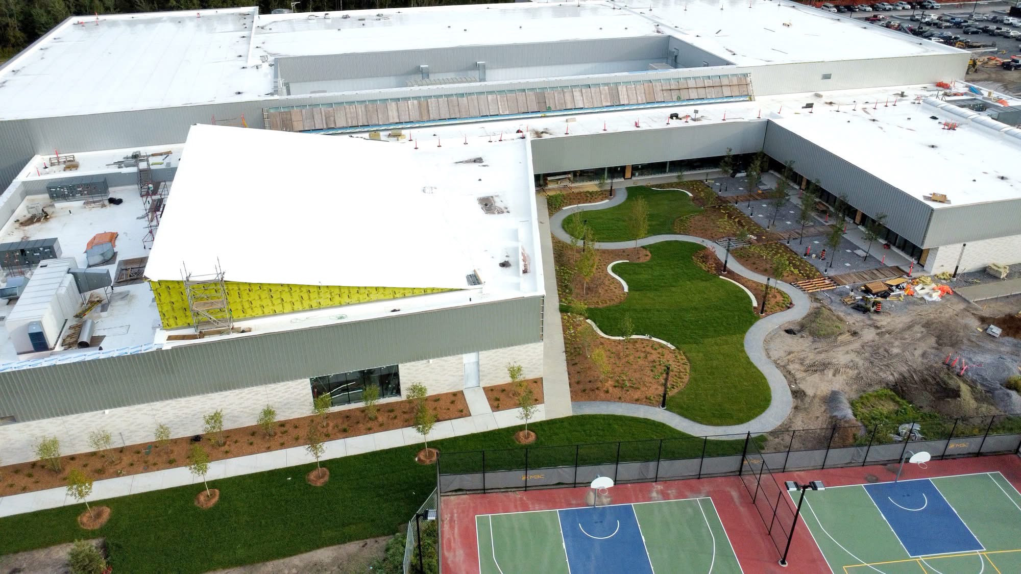 Aerial view of the recreation complex, landscaped courtyard and outdoor courts.